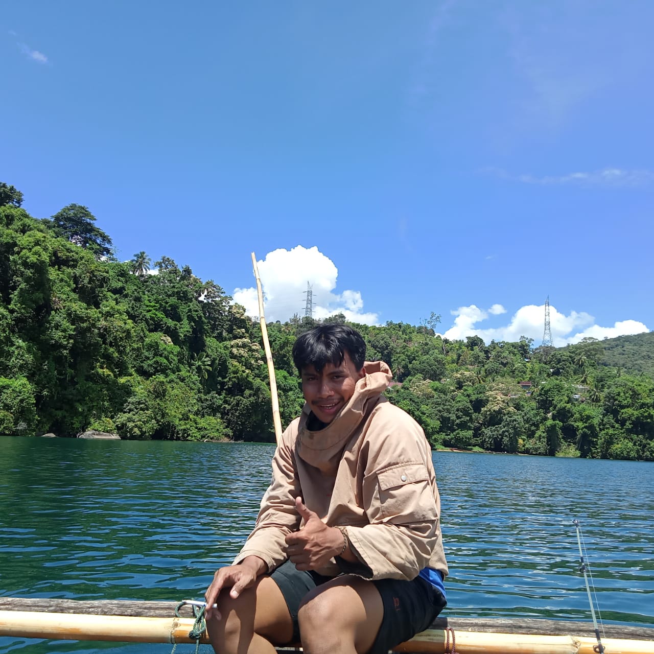 A photograph of a man who works with our partner PROGRES in Sulawesi, sitting on a boat in a lake.